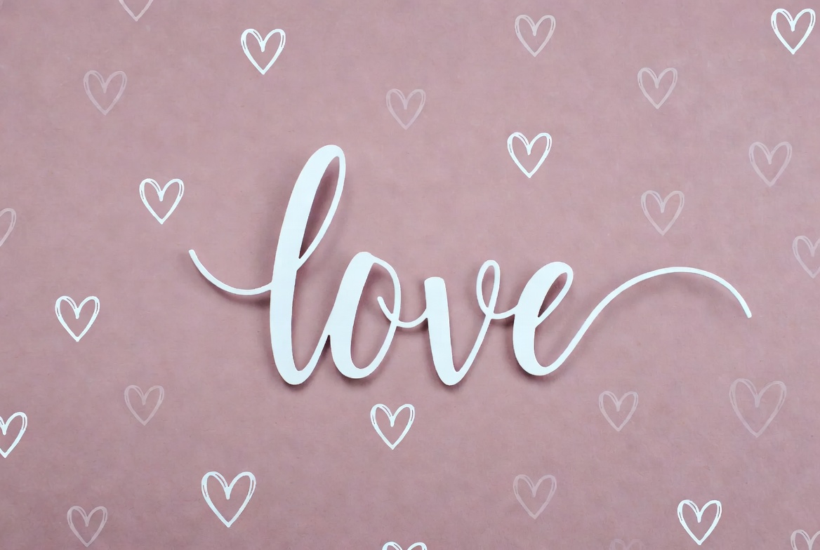 Word love on a pink background with hearts Word love on a pink background with hearts