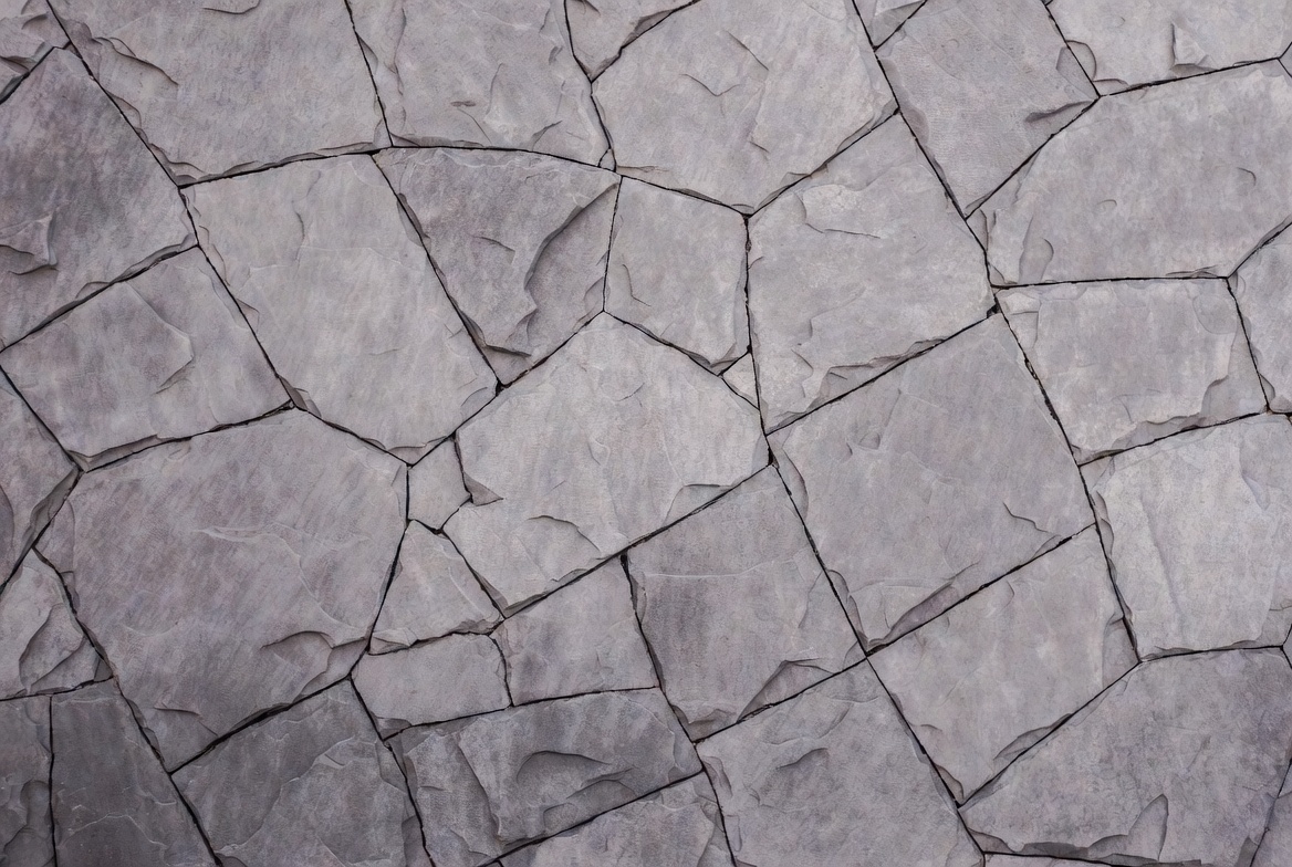 Cracked stone surface in gray shades Cracked stone surface in gray shades