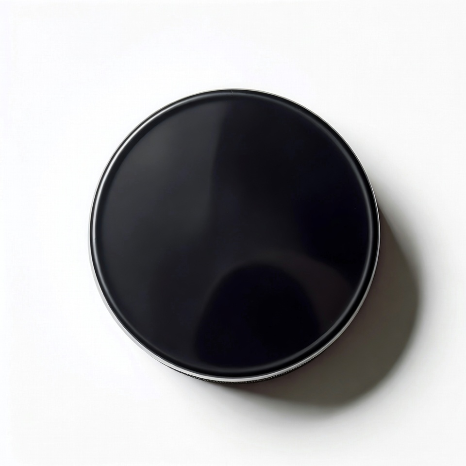 Black round object on white surface Black round object on white surface