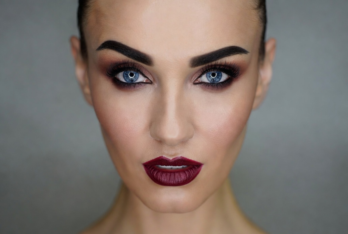Woman with bold makeup and dark lips Woman with bold makeup and dark lips