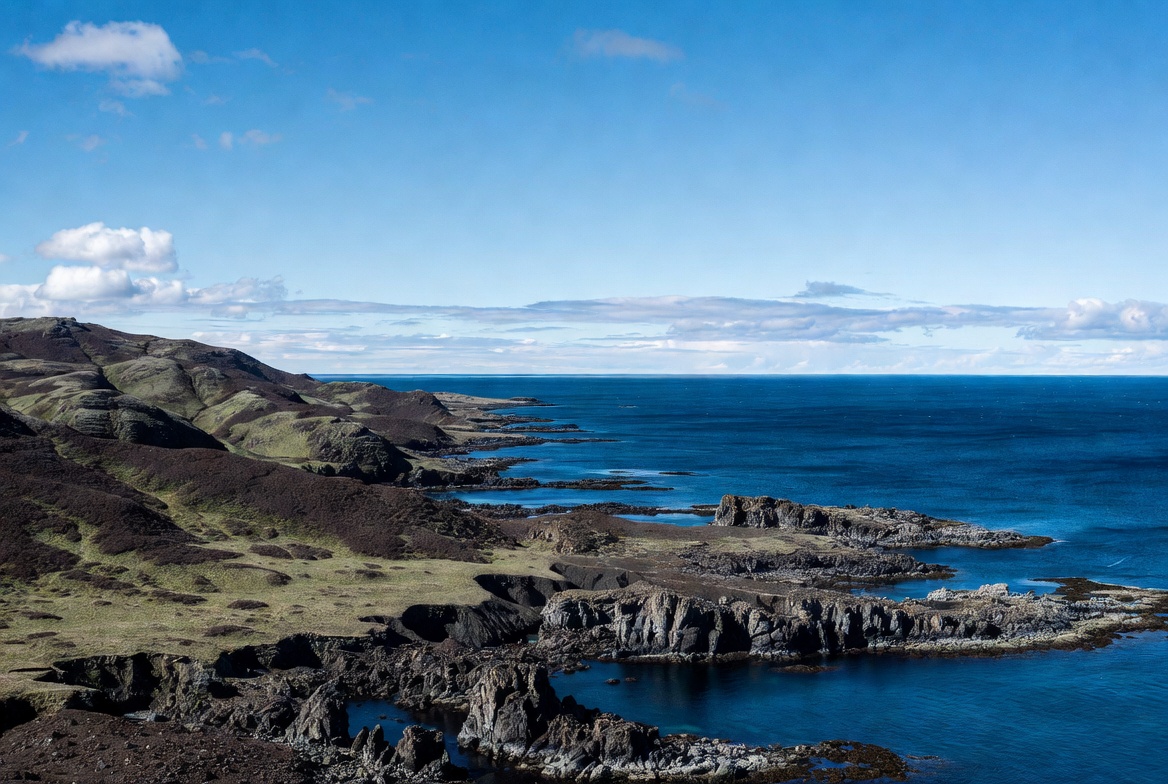 Coastline view with rocky shore and blue water Coastline view with rocky shore and blue water