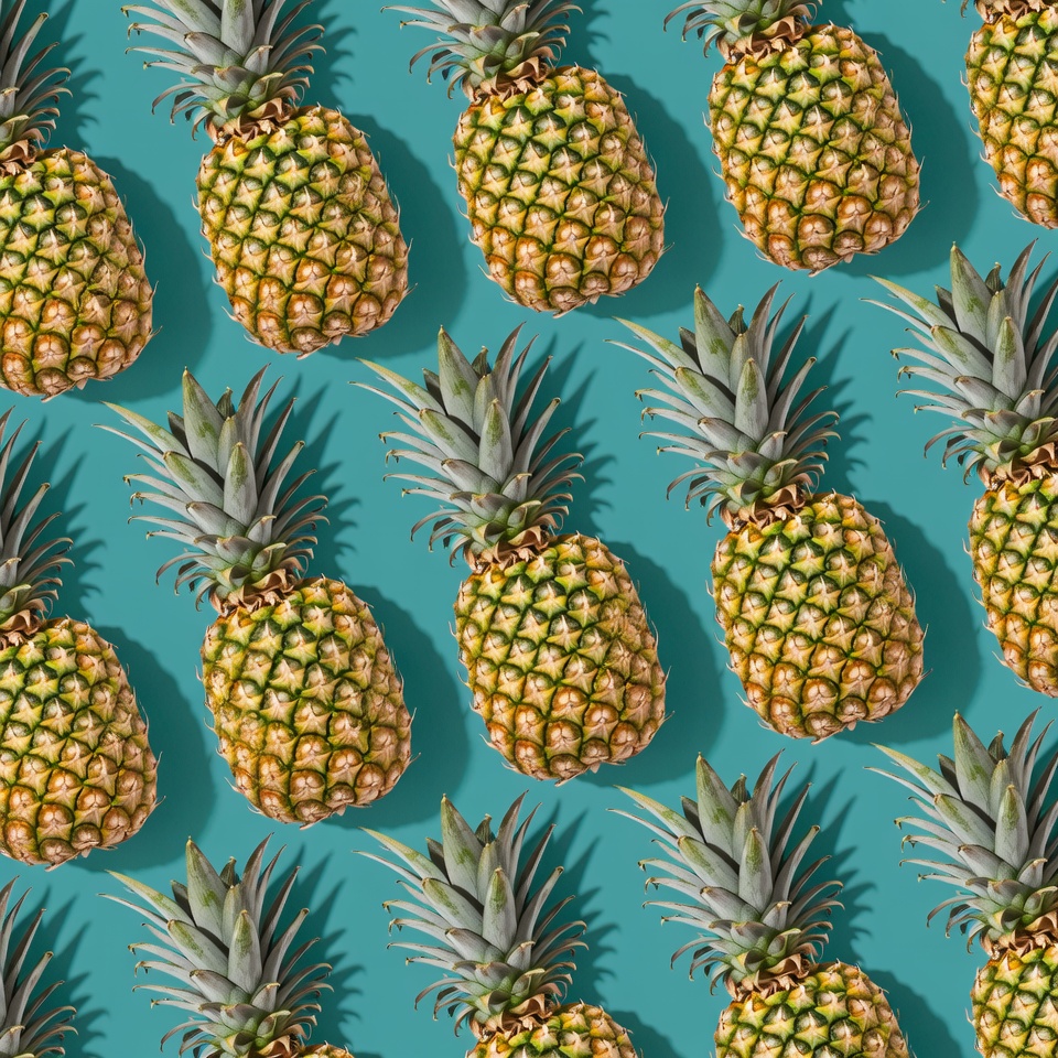 Pineapples arranged on a blue background Pineapples arranged on a blue background