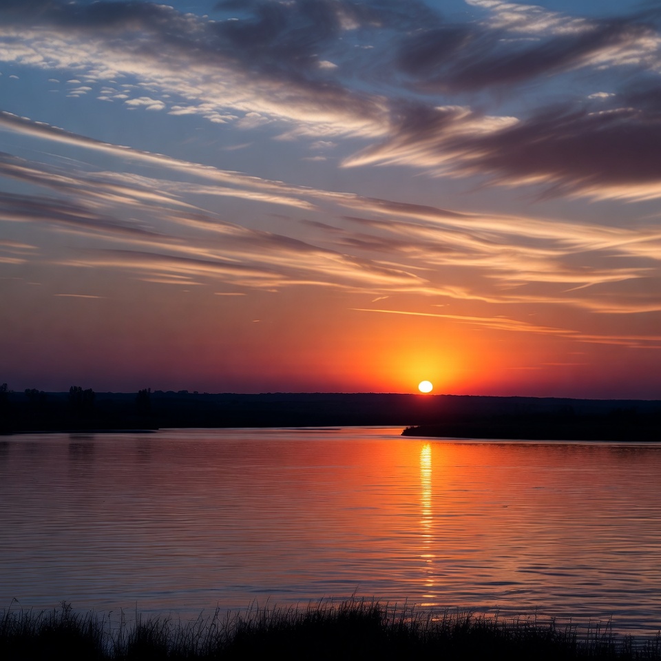 Sunset over calm water horizon Sunset over calm water horizon