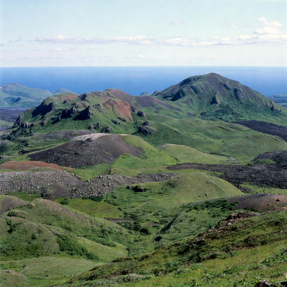 Green hills overlook blue ocean landscape Green hills overlook blue ocean landscape