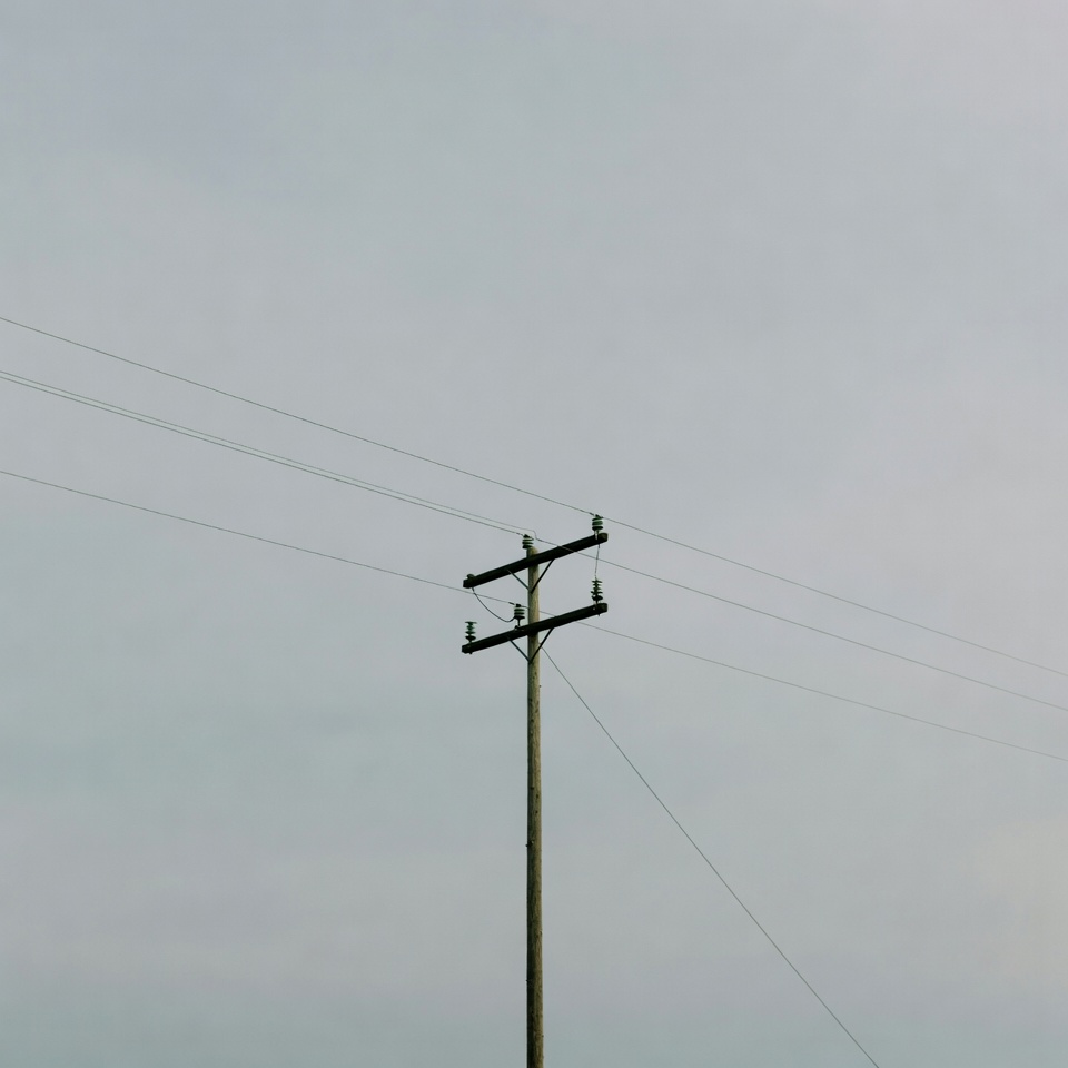 Power pole against gray sky Power pole against gray sky