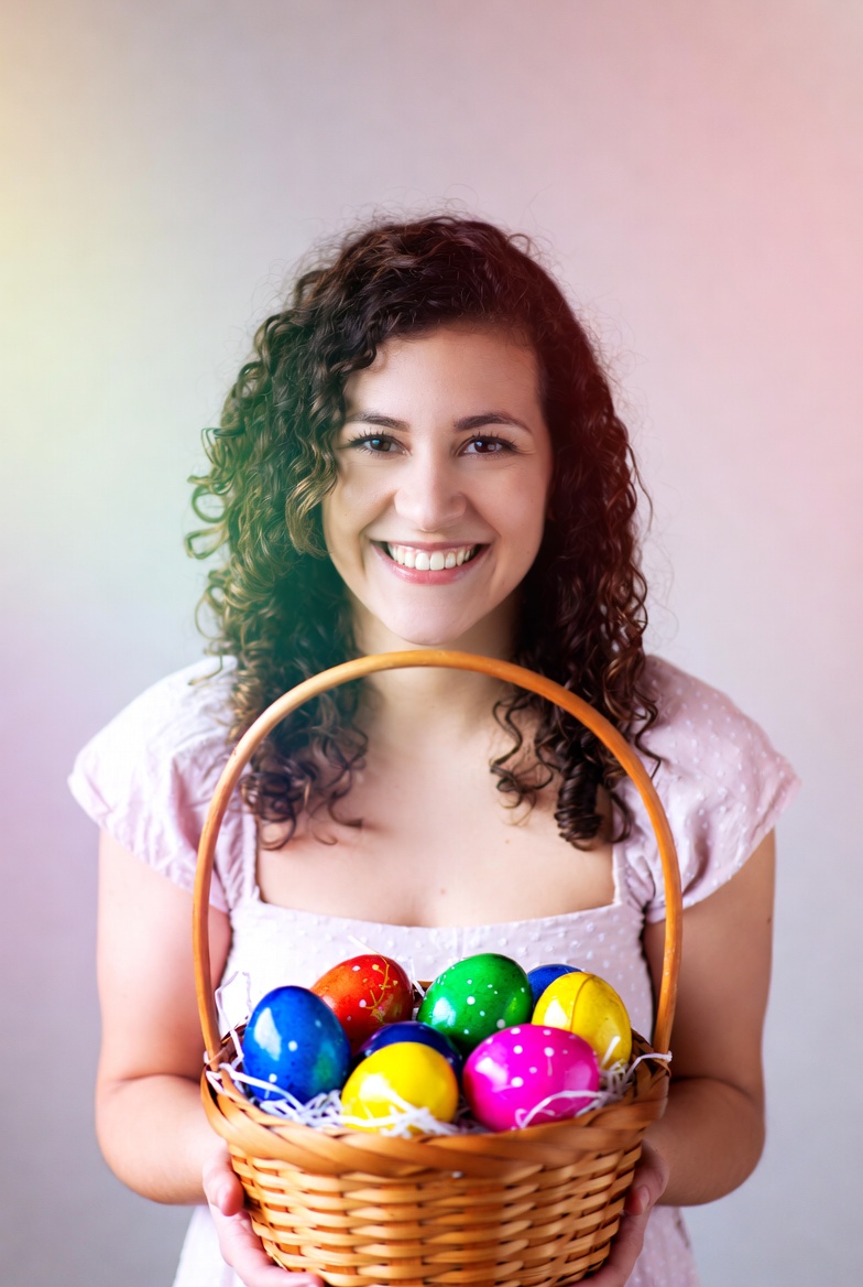 Smiling person holding colorful eggs Smiling person holding colorful eggs