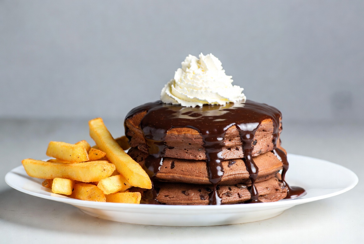 Chocolate pancakes with fries on a plate Chocolate pancakes with fries on a plate