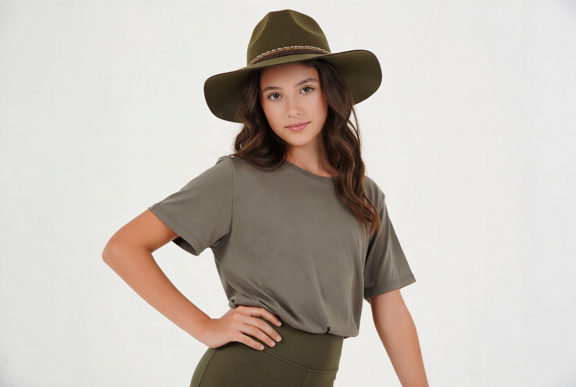 Girl poses in a hat indoors Girl poses in a hat indoors