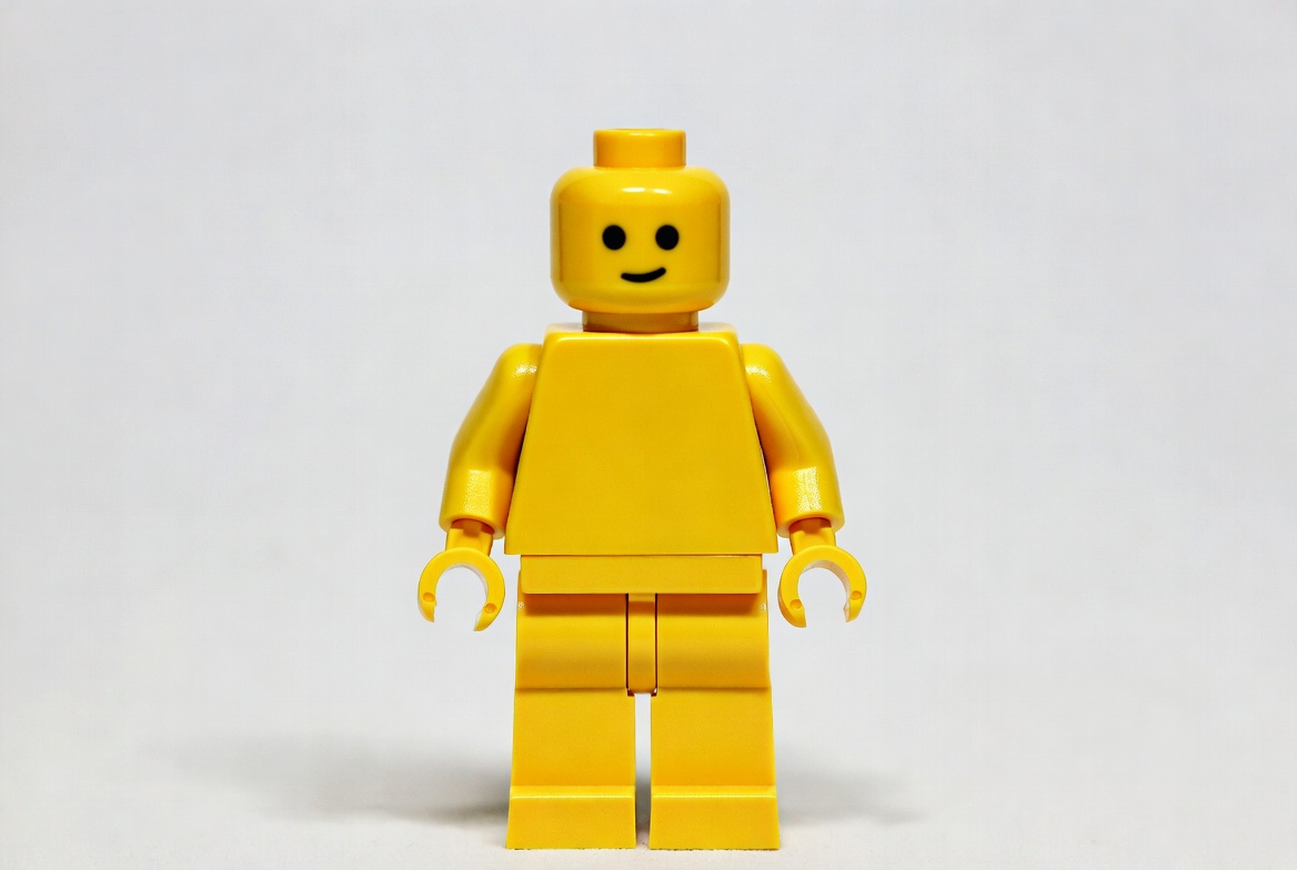 Bright yellow toy figure stands upright Bright yellow toy figure stands upright