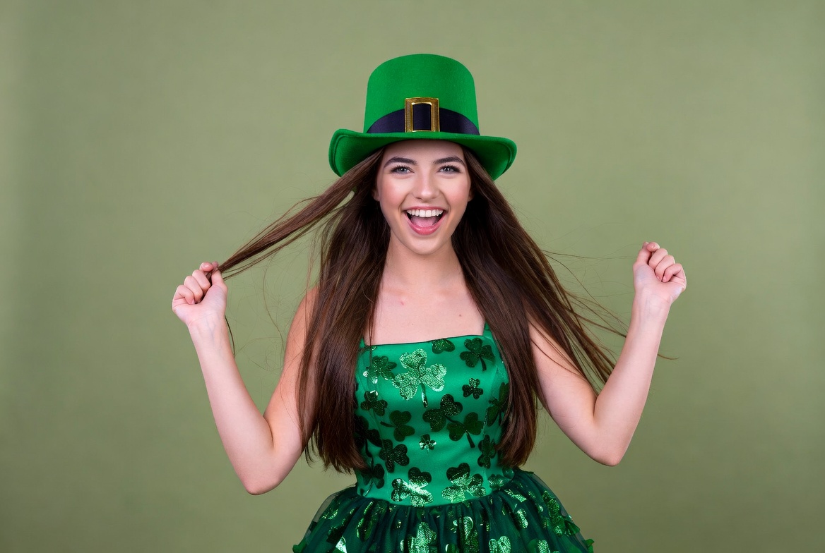 Woman celebrates in green outfit Woman celebrates in green outfit