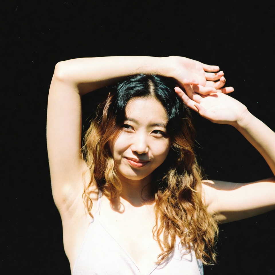 Woman with arms raised in sunlight Woman with arms raised in sunlight