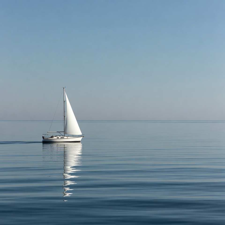 Sailboat on still water at dawn Sailboat on still water at dawn