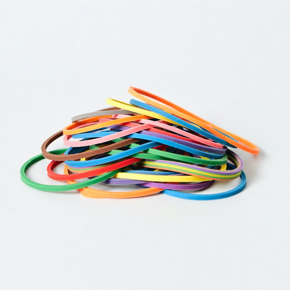 Colorful rubber bands on a white surface Colorful rubber bands on a white surface