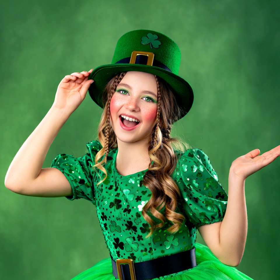 Girl in green costume celebrating holiday Girl in green costume celebrating holiday