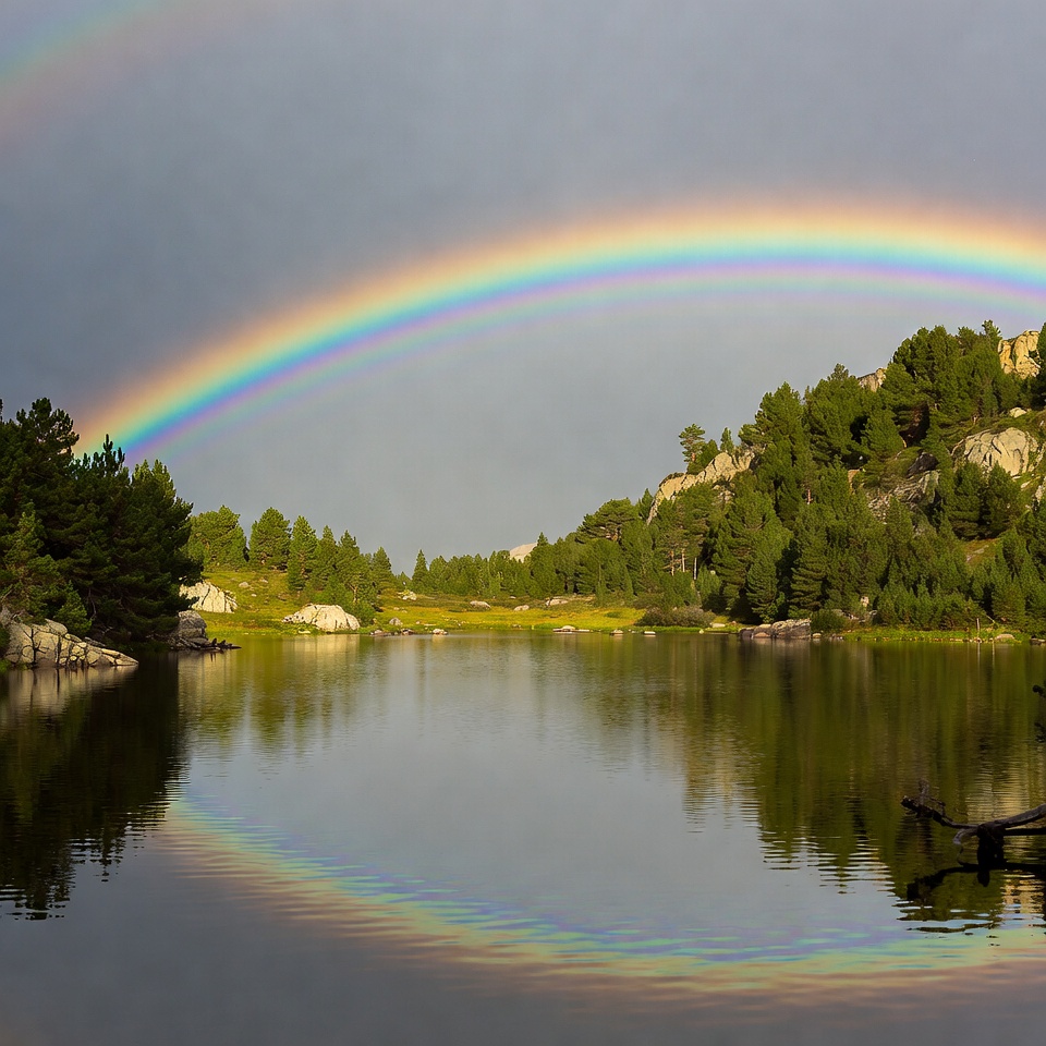 Rainbow over lake at sunset Rainbow over lake at sunset