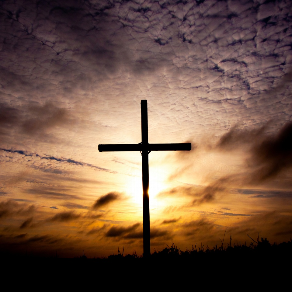 Cross silhouette at sunset in sky Cross silhouette at sunset in sky