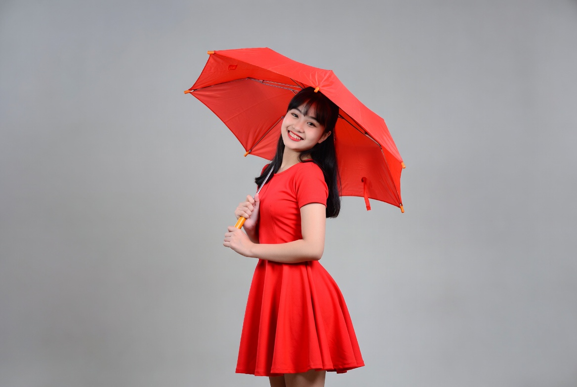 Woman with red umbrella in studio Woman with red umbrella in studio