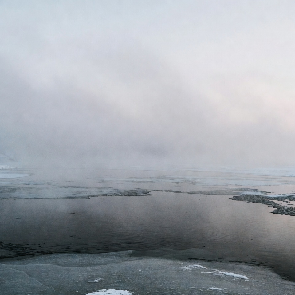 Fog over frozen lake in winter Fog over frozen lake in winter