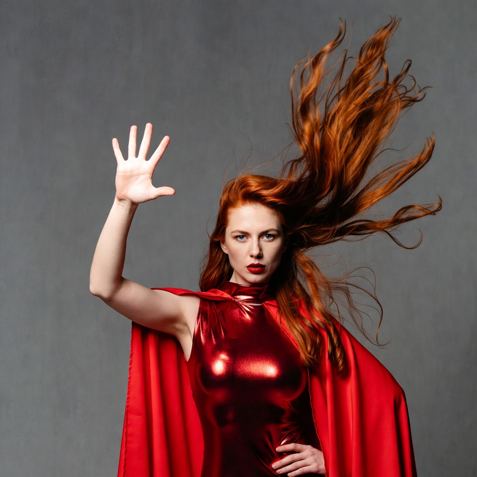 Woman in red cape shows power Woman in red cape shows power