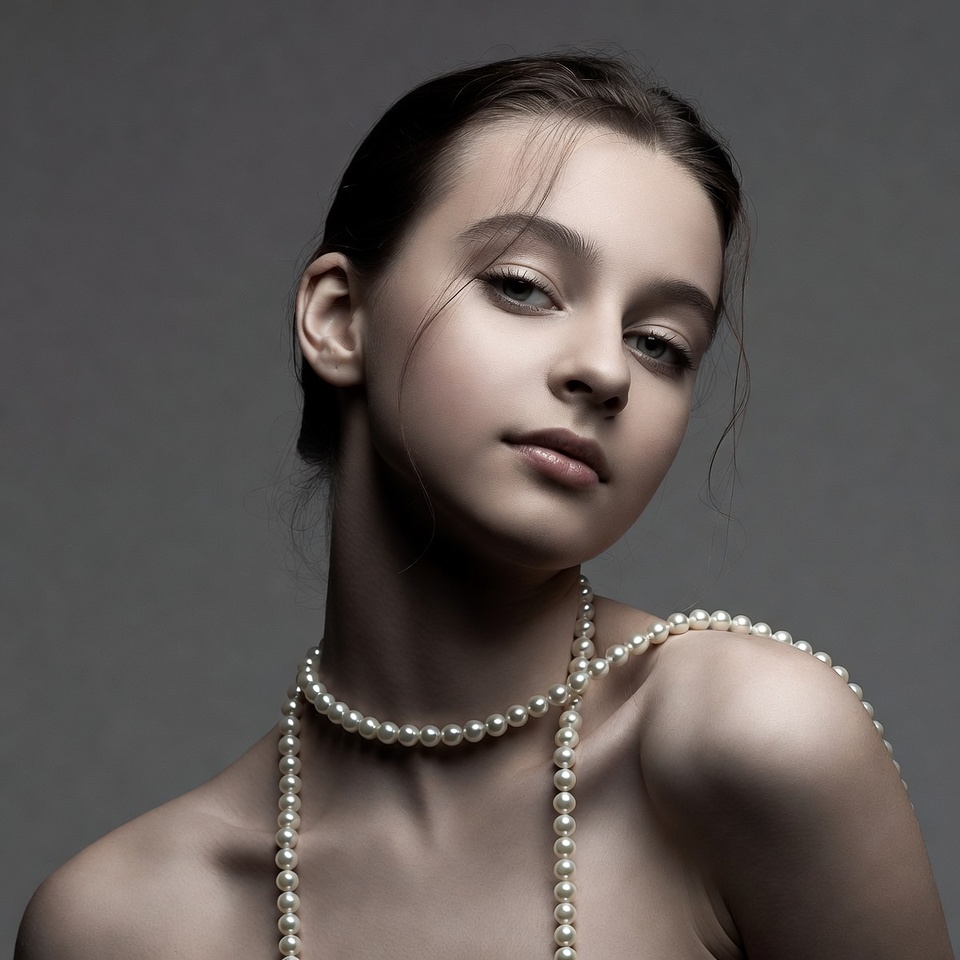 Young girl with pearls on neck Young girl with pearls on neck