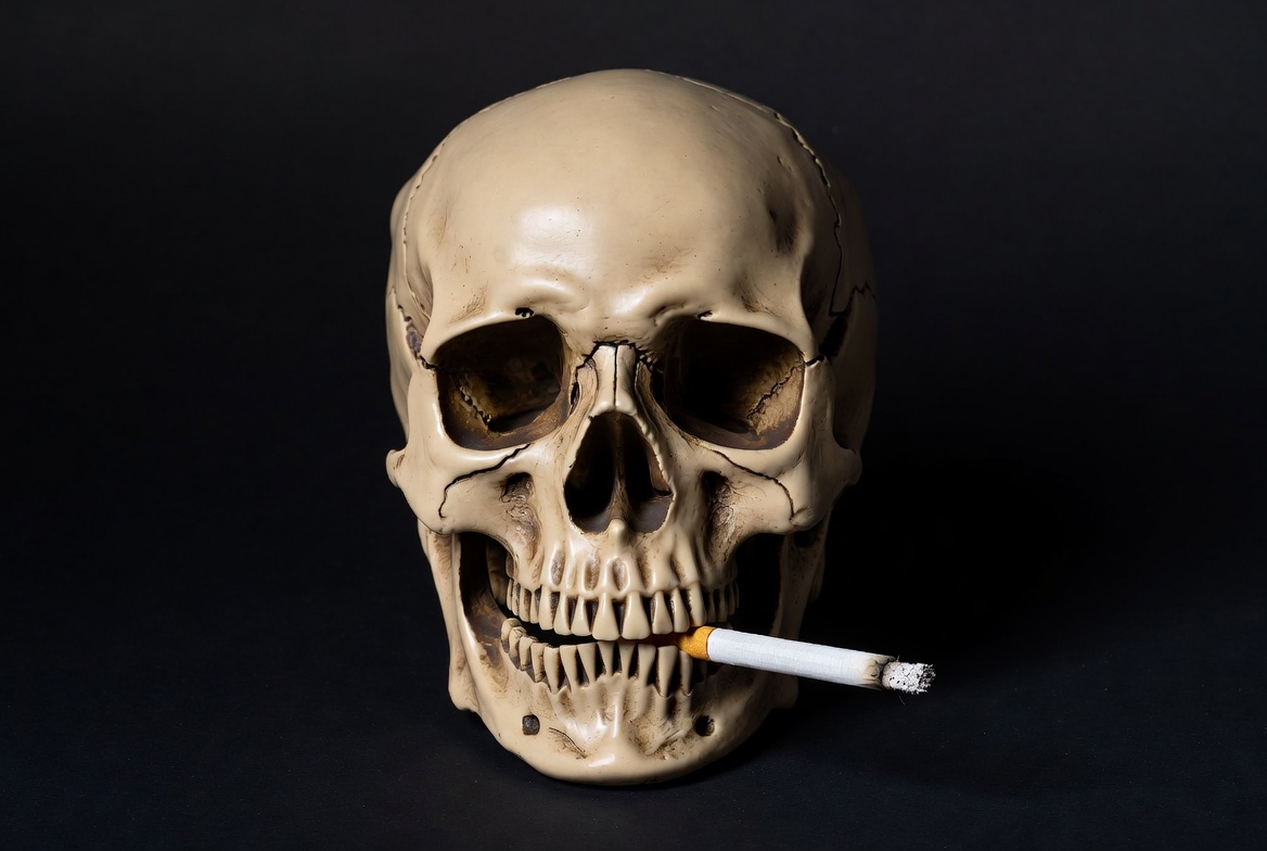 Skull with cigarette in mouth Skull with cigarette in mouth