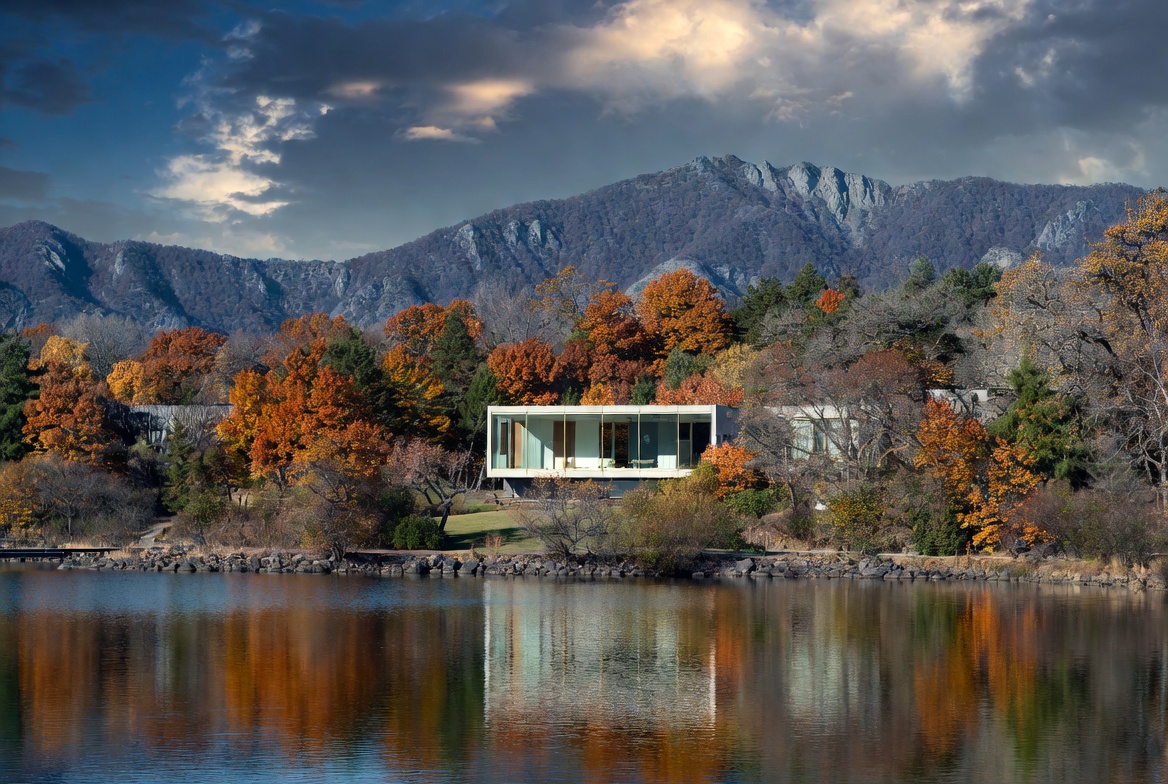 Modern home by the lake in autumn Modern home by the lake in autumn