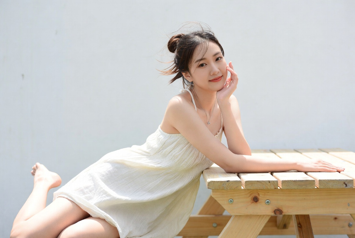 Woman relaxing on wooden bench outside Woman relaxing on wooden bench outside