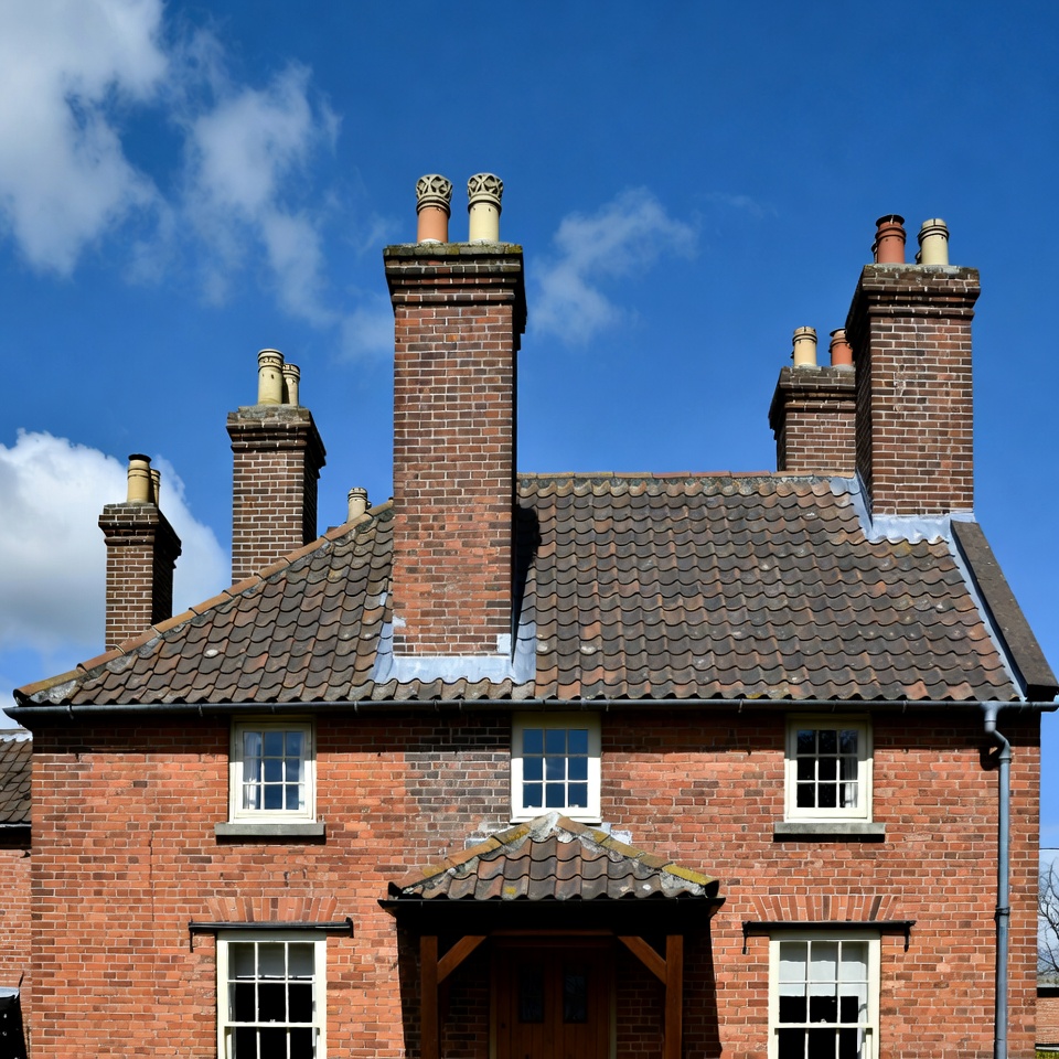 Brick house with multiple chimneys Brick house with multiple chimneys