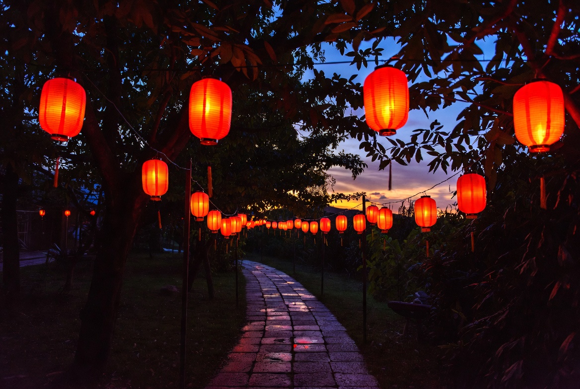Red lanterns hanging over stone path Red lanterns hanging over stone path