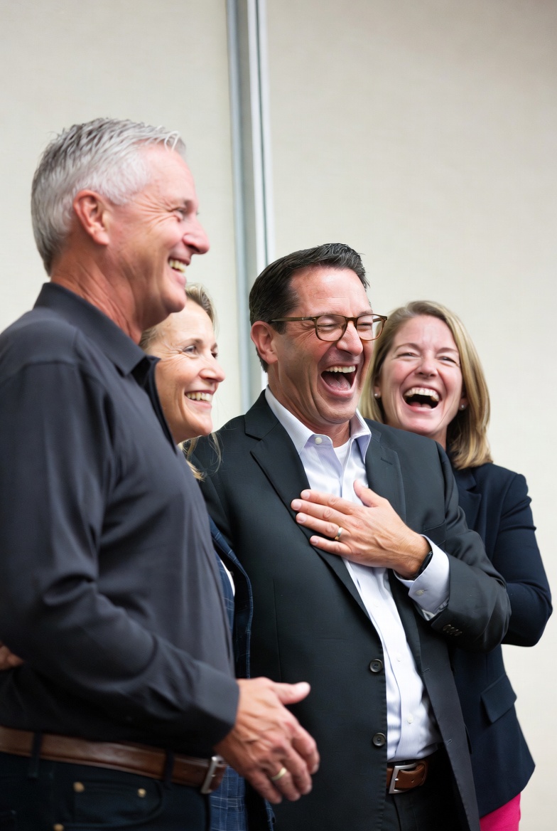 Group of four people laughing together Group of four people laughing together