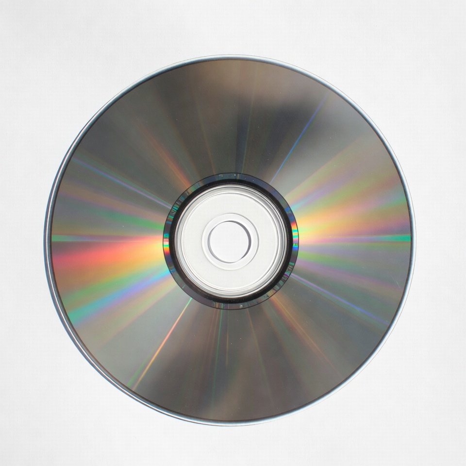 Shiny CD Disc on White Background Shiny CD Disc on White Background