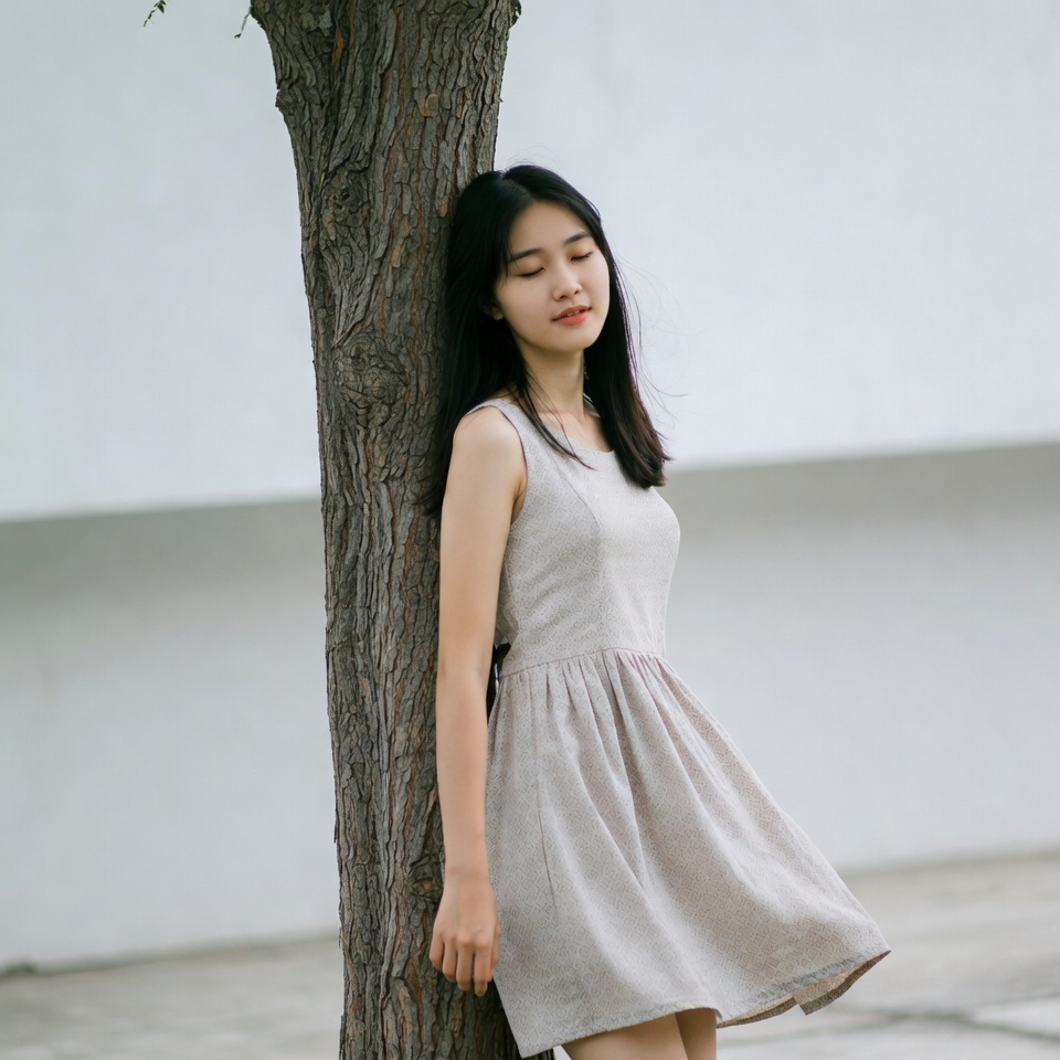 Asian woman leaning against tree Asian woman leaning against tree