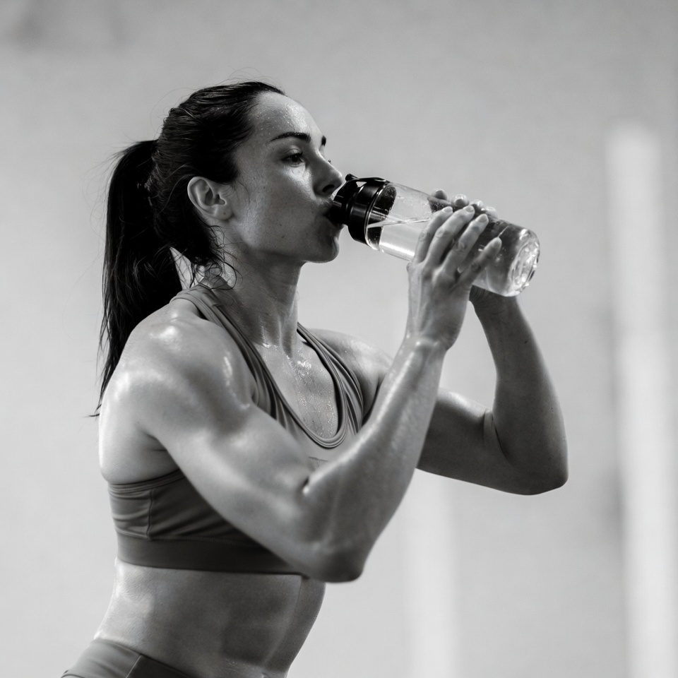 Fit woman drinking water bottle Fit woman drinking water bottle