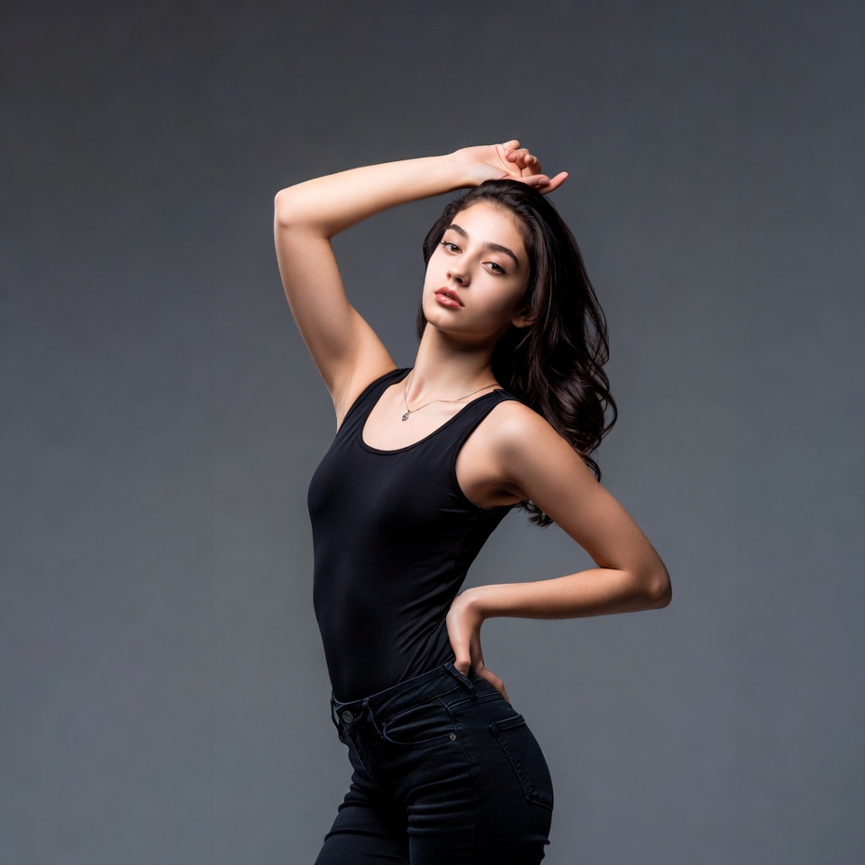 Young woman posing with hand in hair Young woman posing with hand in hair