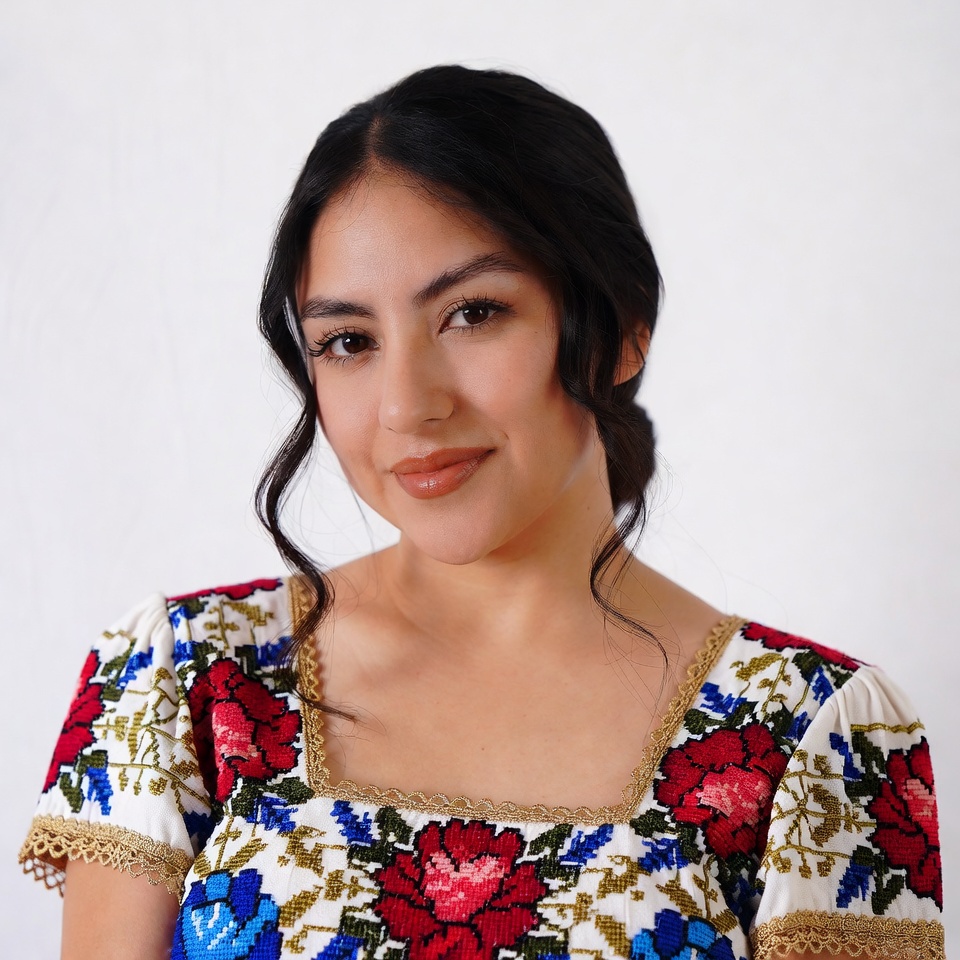 Latina woman in embroidered floral dress Latina woman in embroidered floral dress