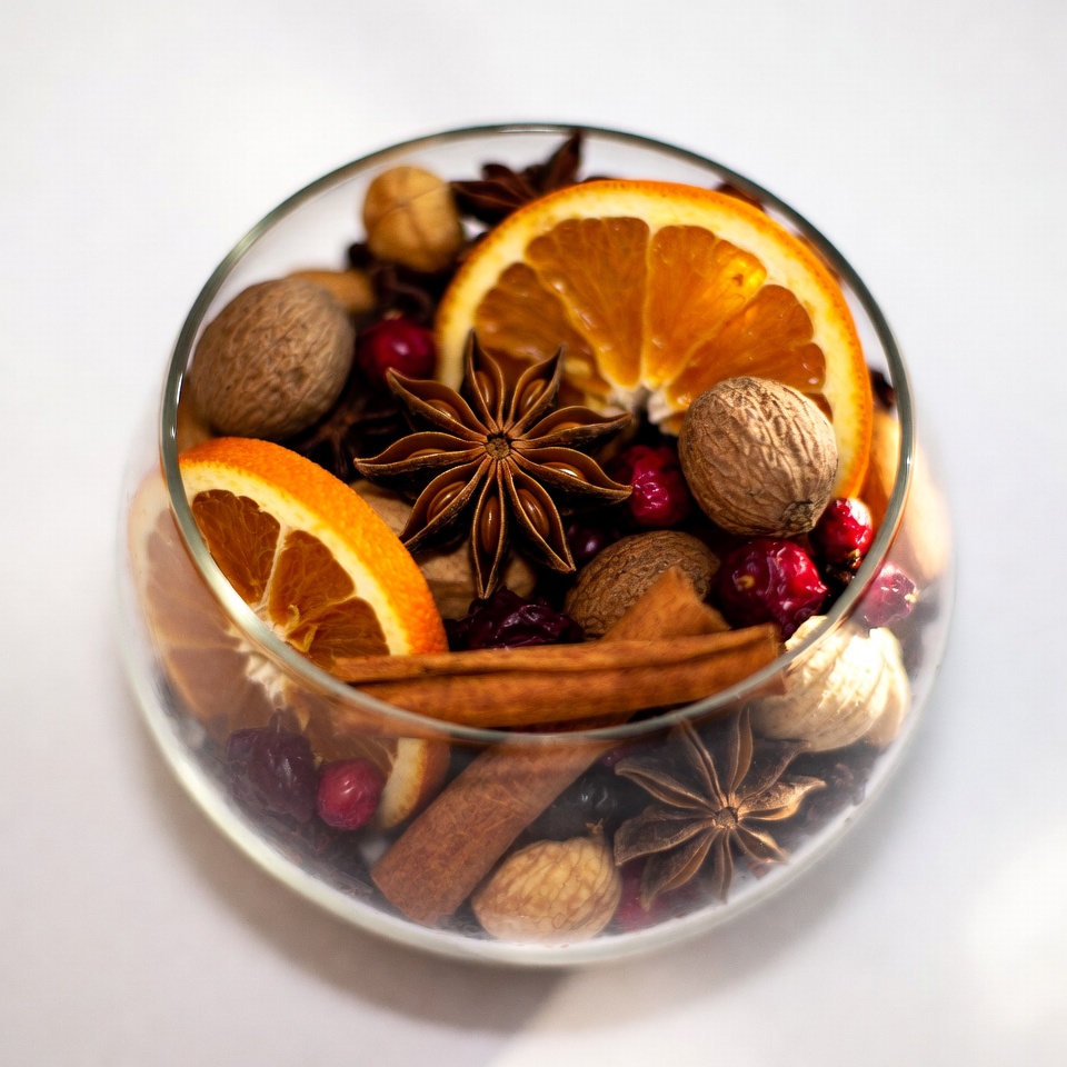 Glass bowl with oranges cranberries nuts spices Glass bowl with oranges cranberries nuts spices