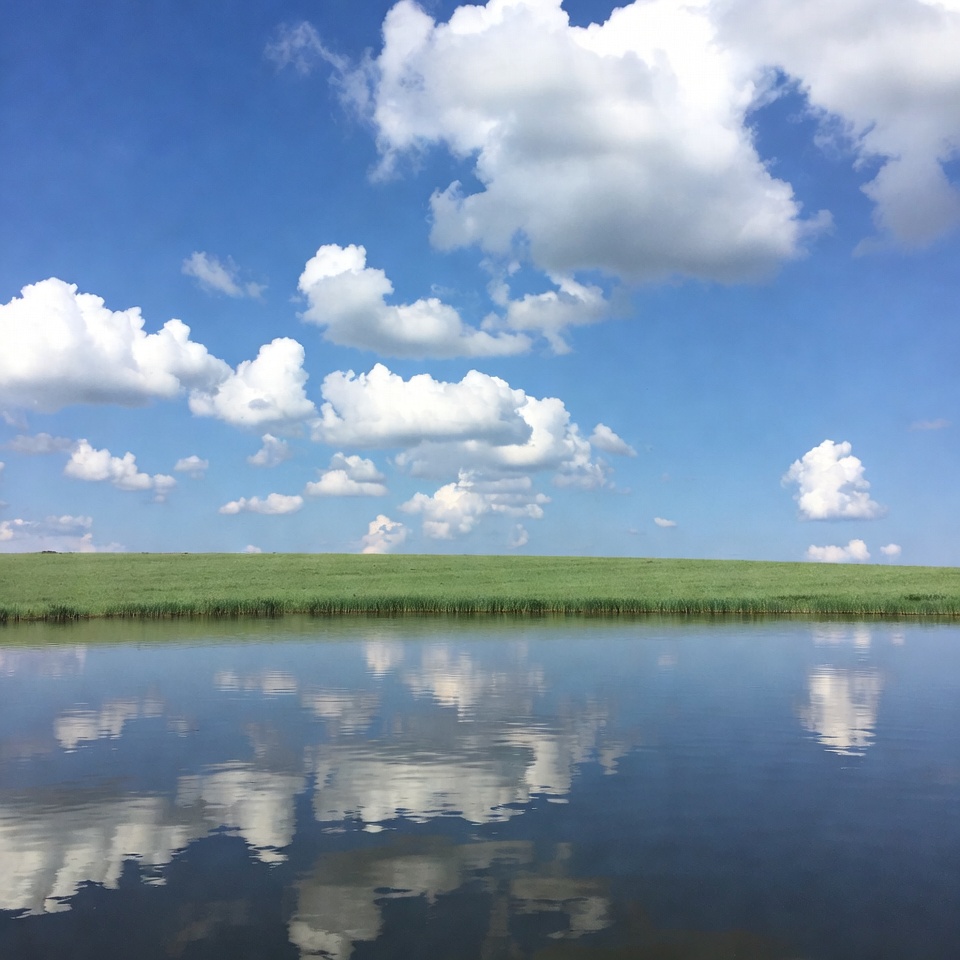 Green Field and Clouds Reflection in Water Green Field and Clouds Reflection in Water