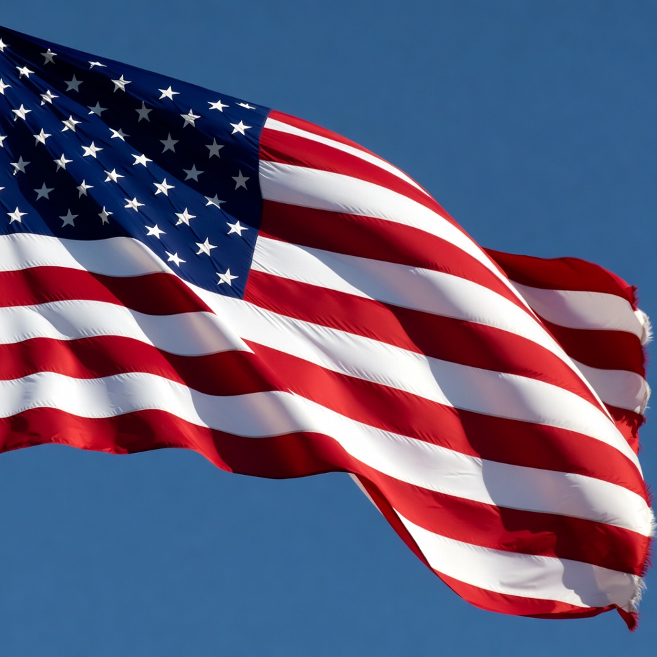 American flag waving against blue sky American flag waving against blue sky