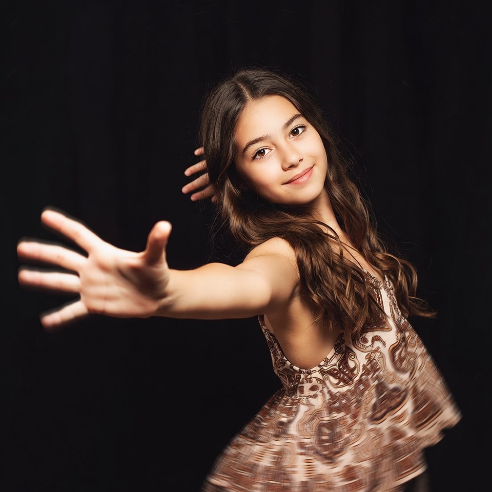 Young girl spreading arms on black background Young girl spreading arms on black background