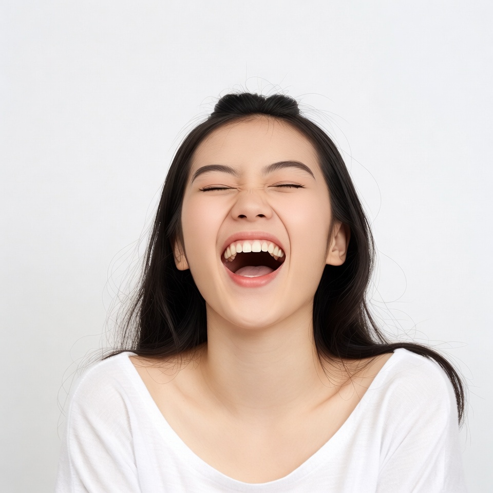 Asian woman laughing joyfully Asian woman laughing joyfully