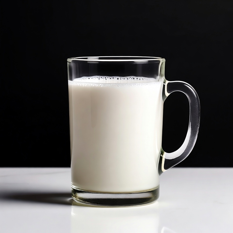 Glass of milk on white surface Glass of milk on white surface