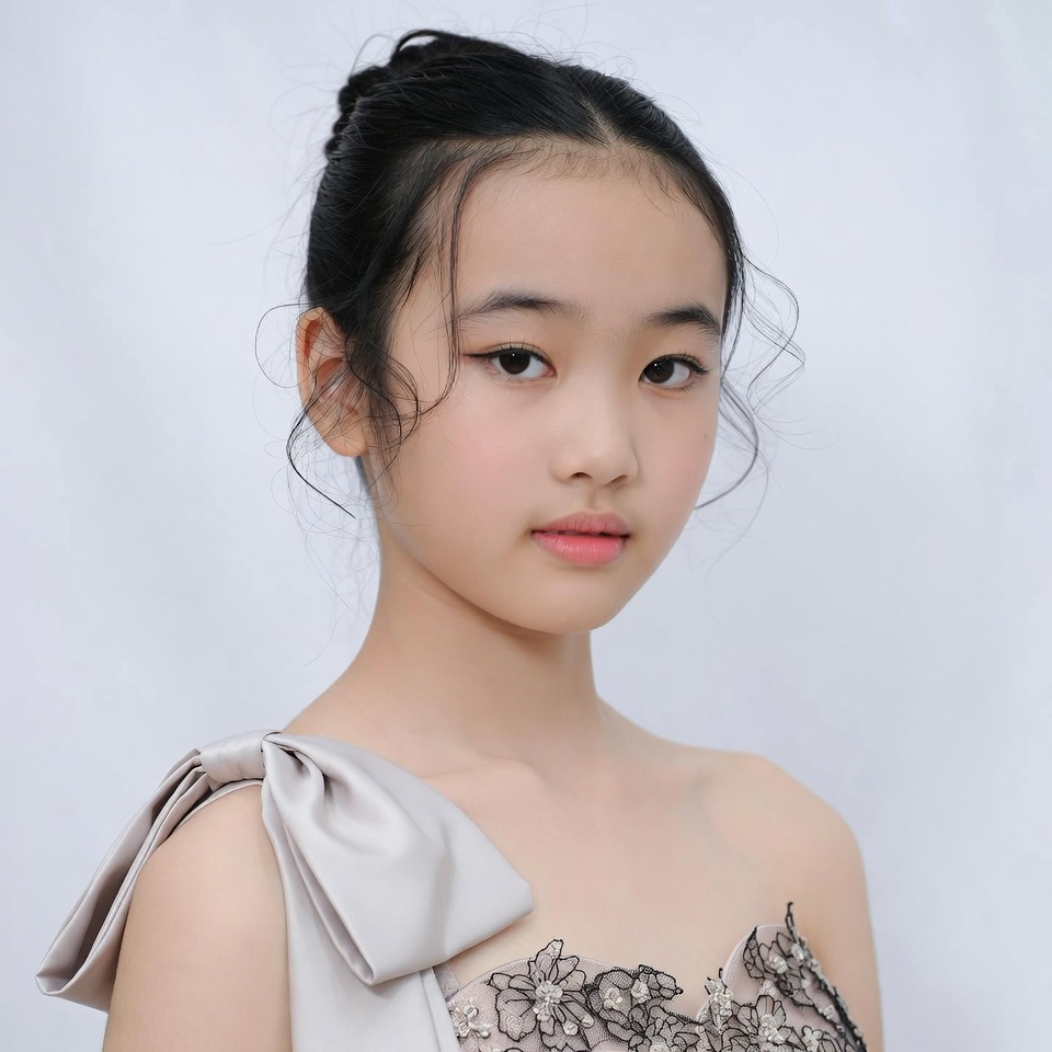 Asian girl in lace gown with bow Asian girl in lace gown with bow