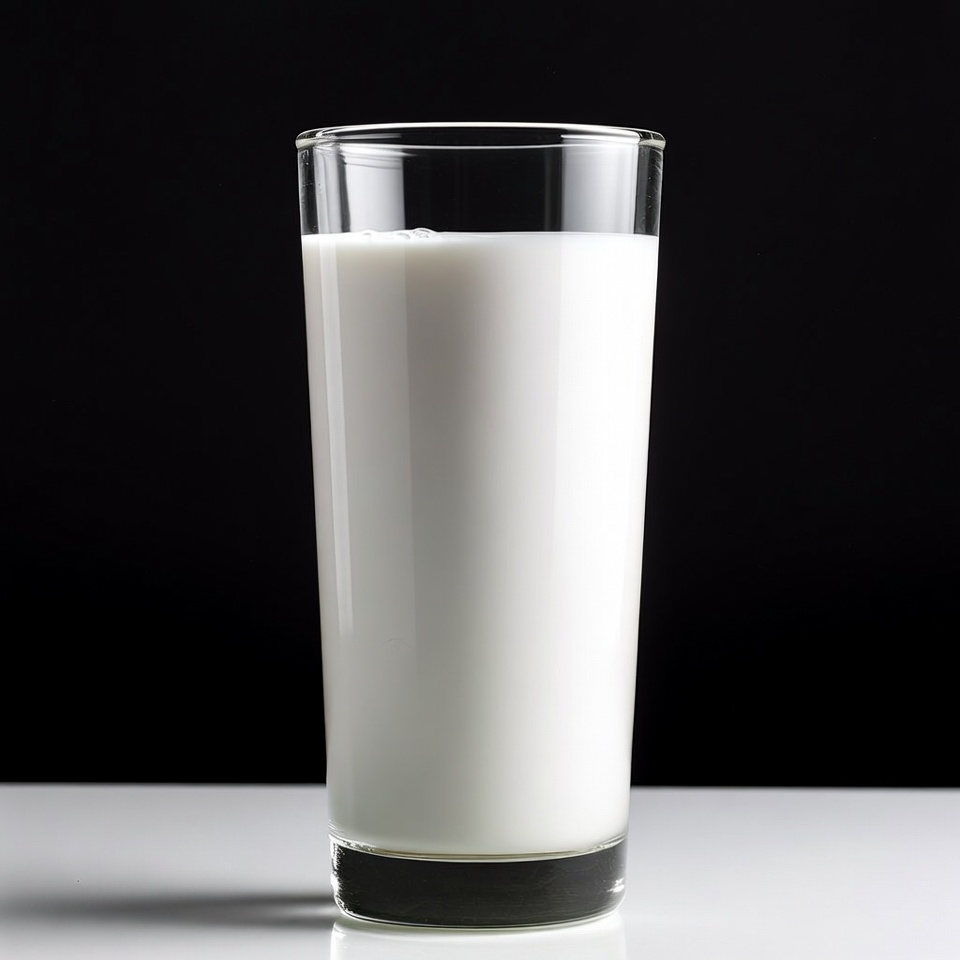 Glass of milk on white surface Glass of milk on white surface