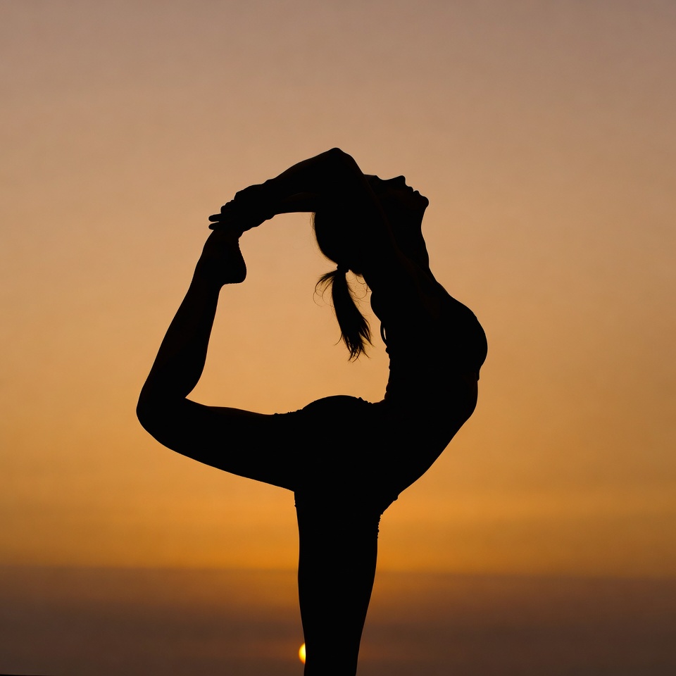 Woman in yoga scorpion pose silhouette Woman in yoga scorpion pose silhouette