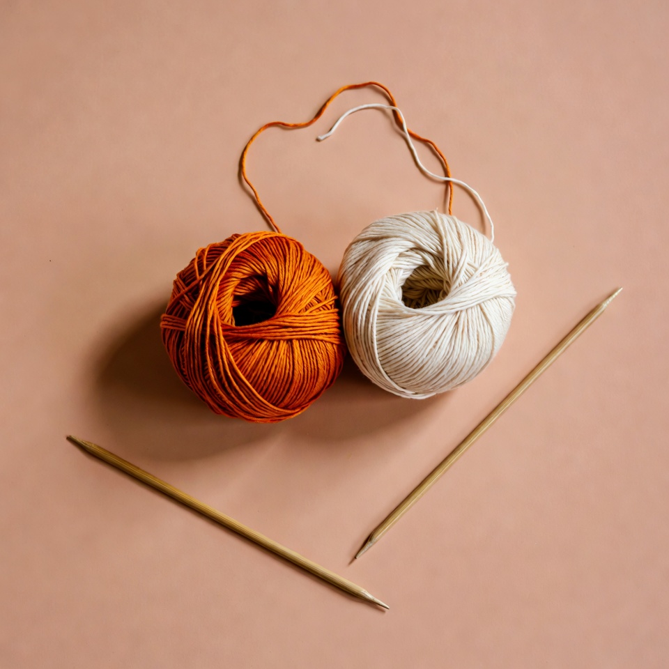 Orange and White Yarn Balls with Knitting Needles Orange and White Yarn Balls with Knitting Needles