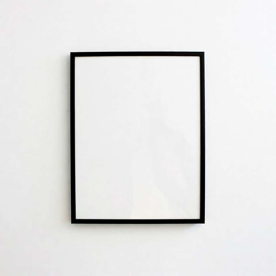 Empty black picture frame on white wall Empty black picture frame on white wall