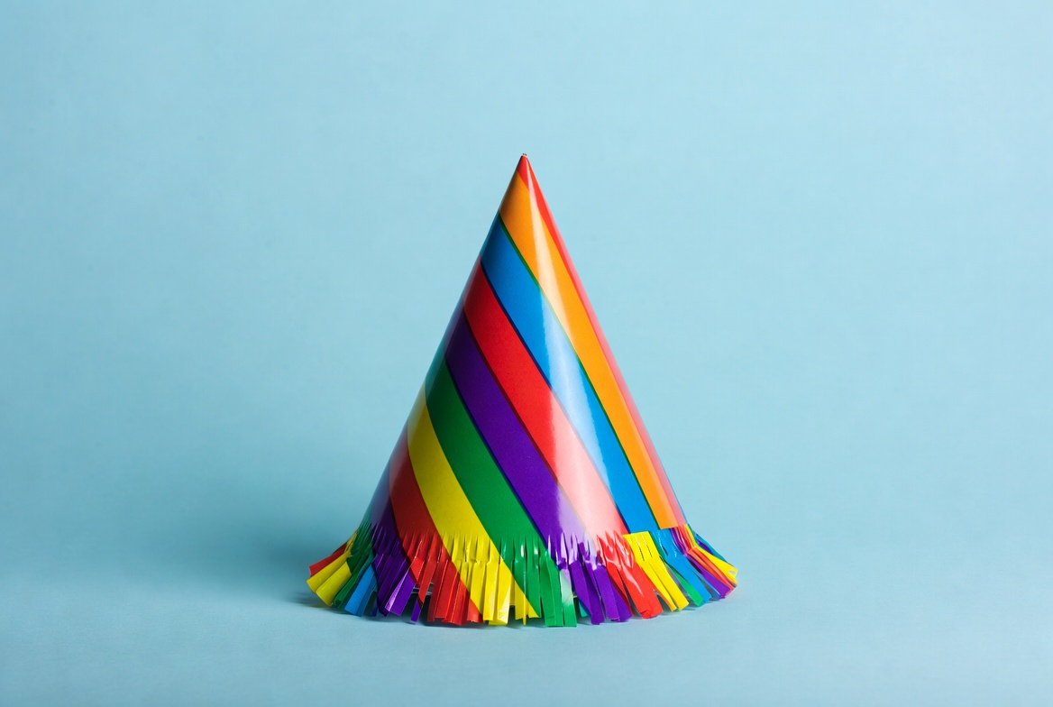 Rainbow Party Hat on Blue Background Rainbow Party Hat on Blue Background