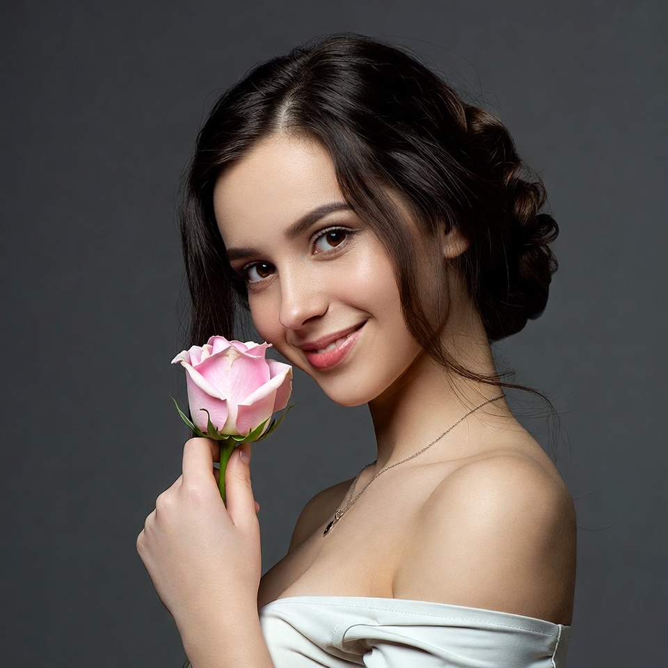 Woman holding pink rose Woman holding pink rose