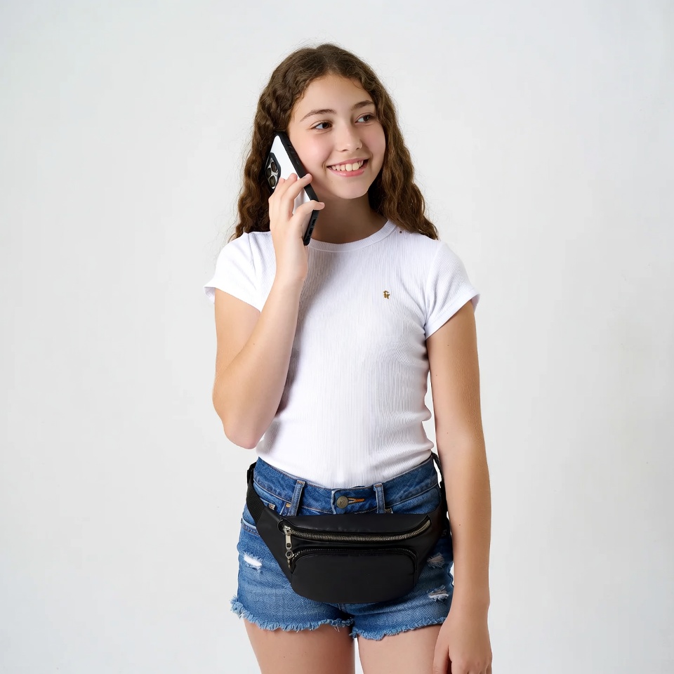Girl talking on phone with fanny pack Girl talking on phone with fanny pack