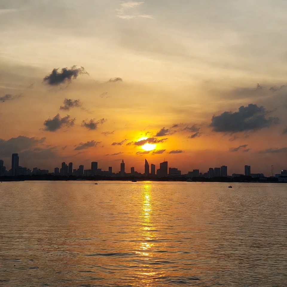 Sunset over city skyline and water Sunset over city skyline and water